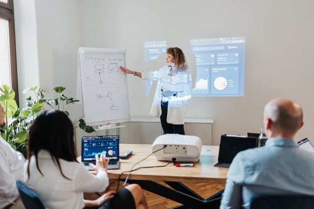 Engenious specialist presenting information to colleagues in a meeting room