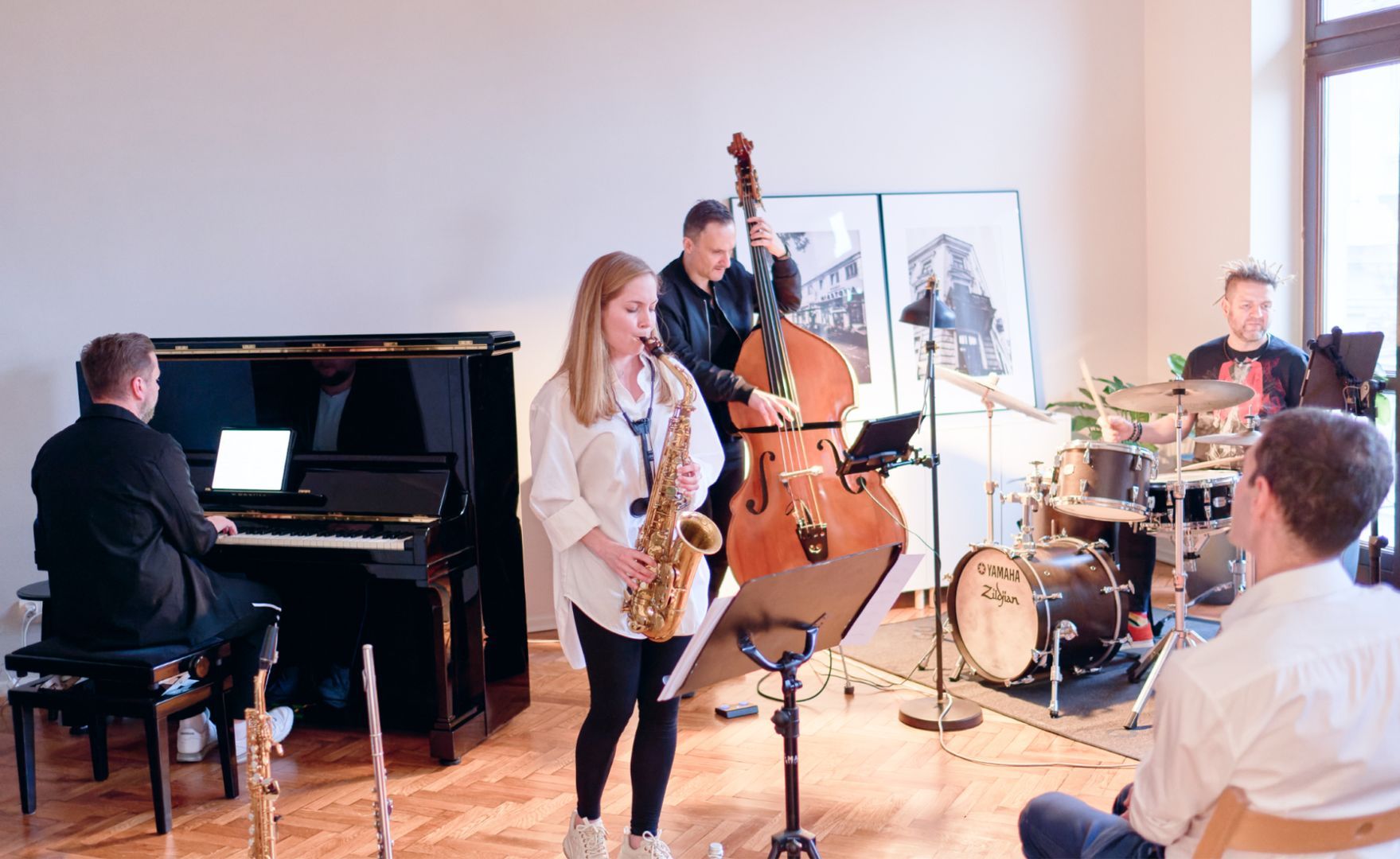 Musicians playing piano, saxophone, double bass and drums at Engenious