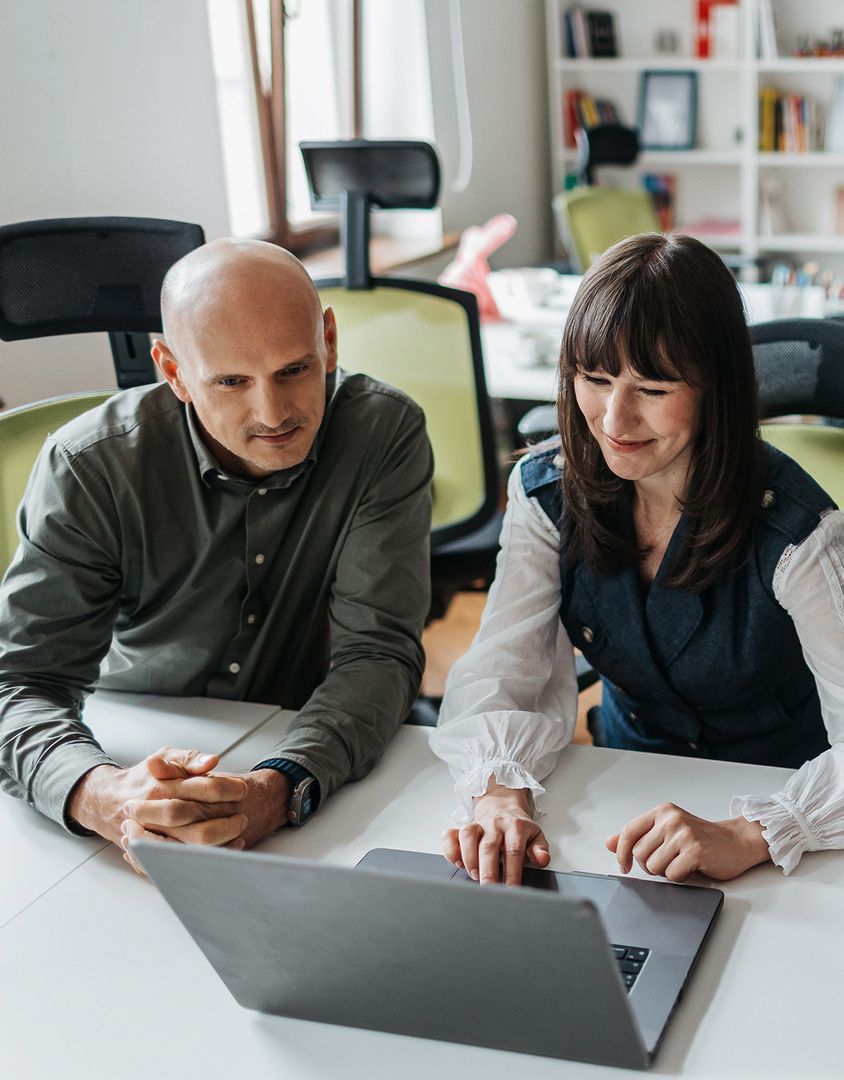 Two Engenious colleagues reviewing a project on a laptop