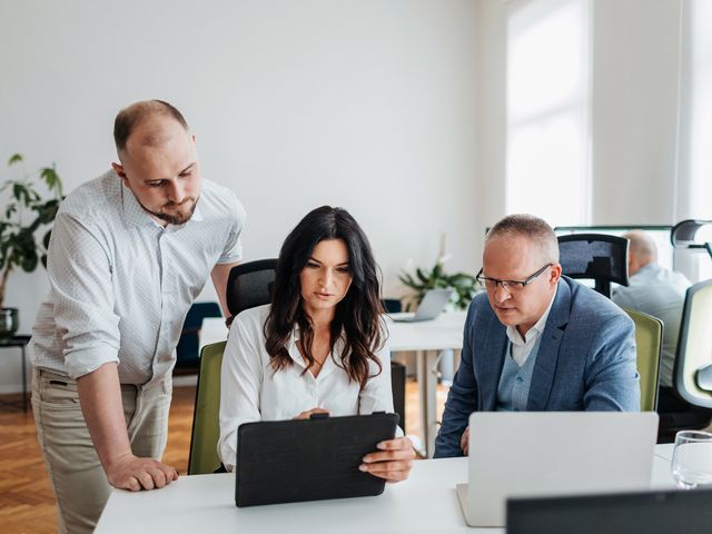 Three Engenious colleagues reviewing work on a laptop